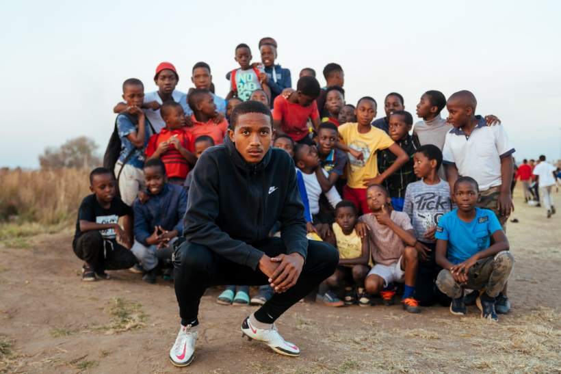 Black Arrow FC — a player with the young supporters